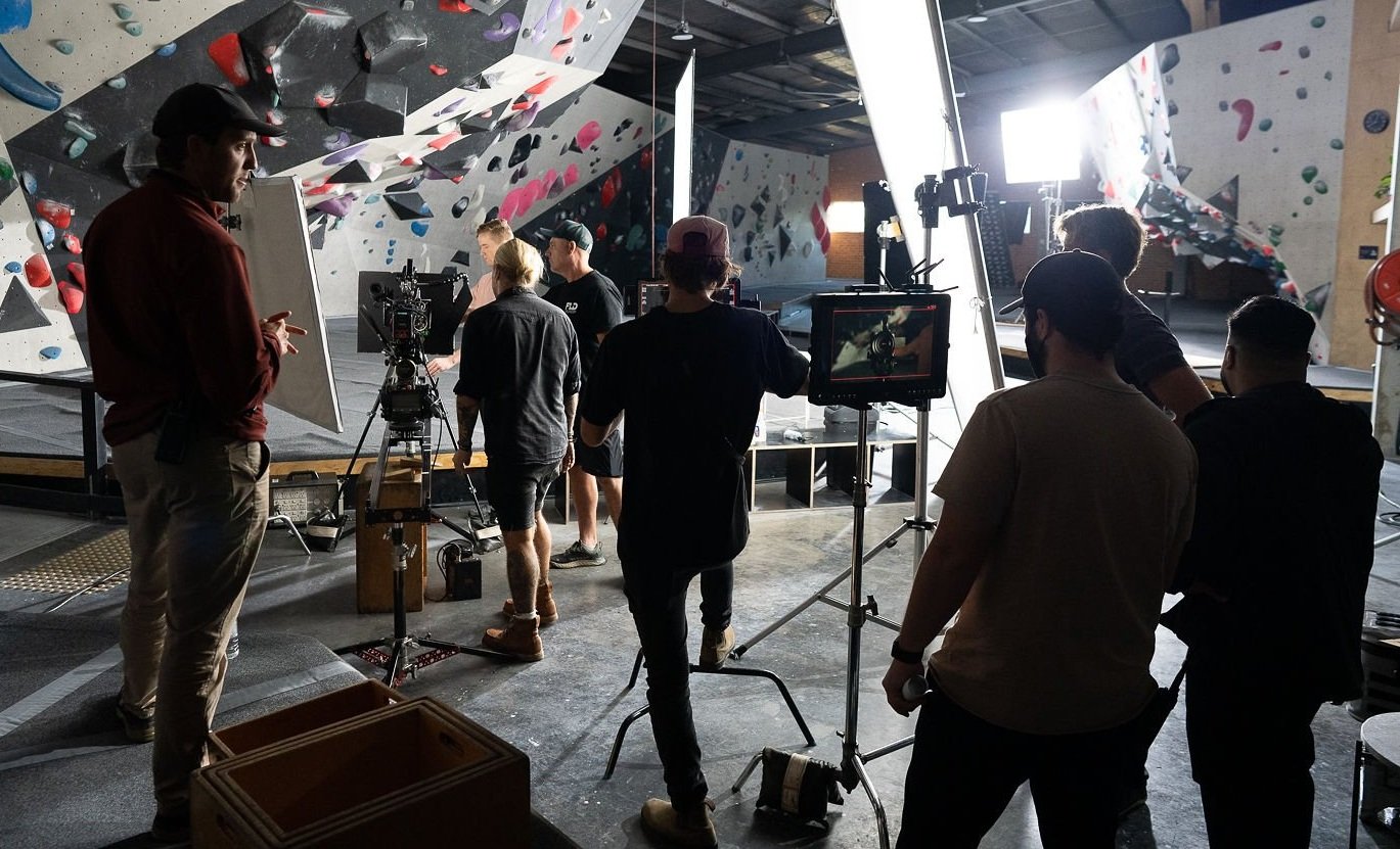 Crew around a camera and monitor inside a climbing gym, published with the Sony Cinema Line behind-the-scenes film.