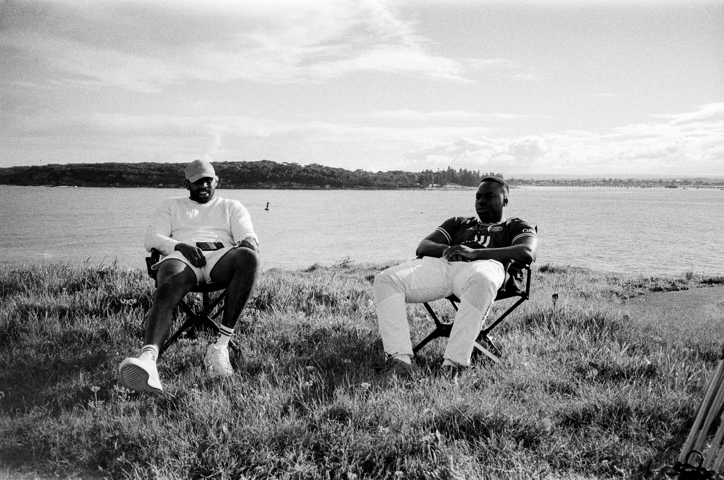 Two people seated in chairs above the water, the still used for Personal Projects.